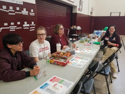 NHS Students handing out food to those who donated