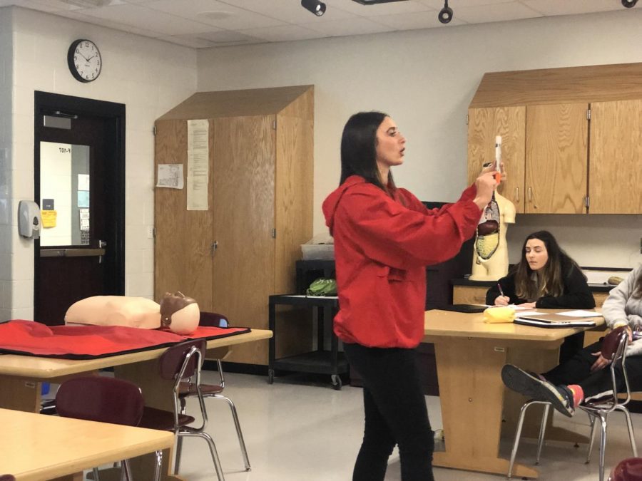 First aid teacher Ms. Sara Davis teaches students how to use an Epi-Pen. 