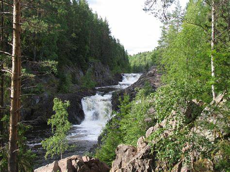 A beautiful nature scene showing a waterfall and trees. 