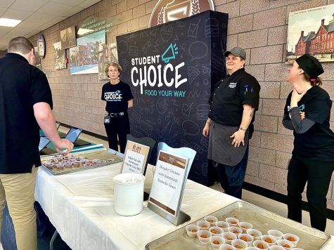 Photo of the Day- Yesterday during lunches the school held a tasting table where students could try new and different samples of food, and then vote on which of the meals they would like to see for lunch. The samples available were pulled pork and breaded chicken. This event had a lot of students interested in what kind of meals the school could serve.