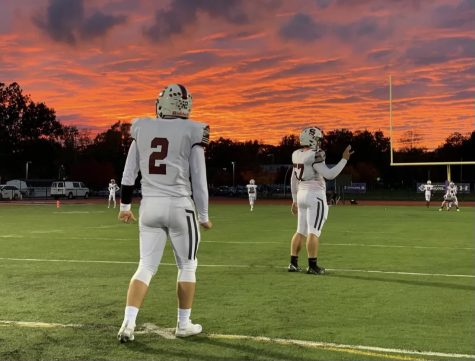 Juniors Ethan Sodl, 2, and Xavier Dorst, 57, prepare pregame.