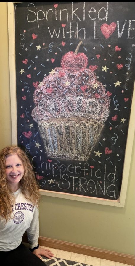 Ms. Fornataro standing next to a chalk board with a cupcake stating Sprinkled with Love