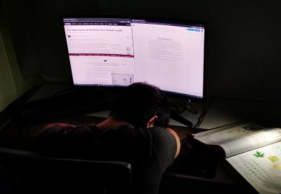 Teenager falls asleep as he is working on a school assignment