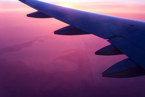Flying airplane displaying the beautiful sunset from up in the sky
