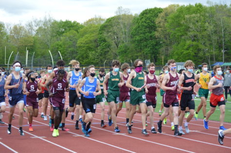 Multiple teams make their way to the start line before the boys 4x800m relay at the EPC Championship.