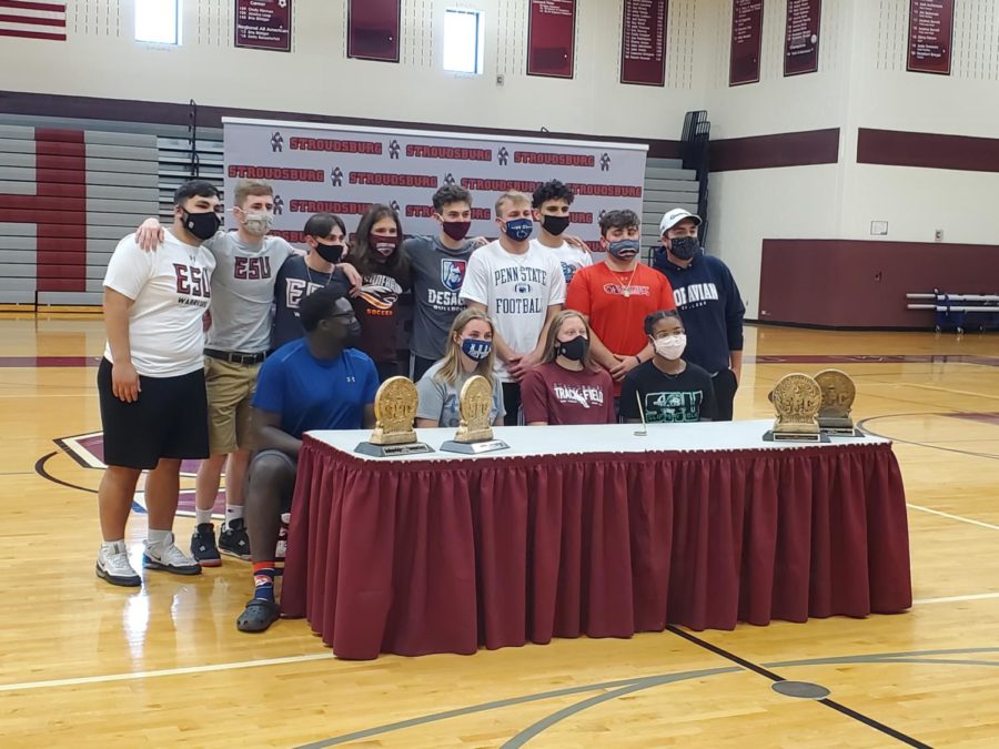 13+student-athletes+signed+with+their+future+schools+in+the+high+school+gymnasium+Friday+afternoon.