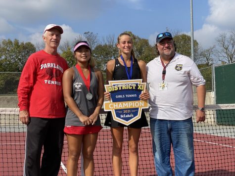 Paraskevi Briegel stands alongside her opponent Erin Joo, left, and coach Gene Taprio, right, as she holds her District XI championship poster.