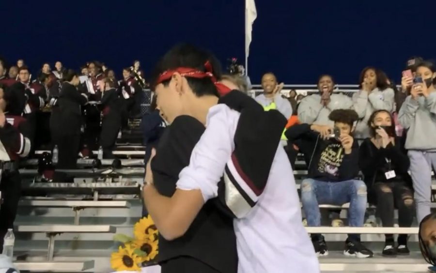Chris Hu and Bella Snyder during Chris homecoming proposal at a Friday Night Football Game.