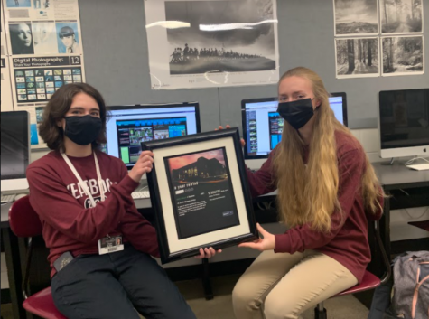 Seniors Rachel Bailey and Hope Butler showing off a plaque of last years Yearbook. 