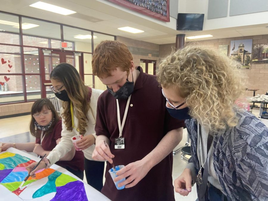 Best buddies work on new banner with members.