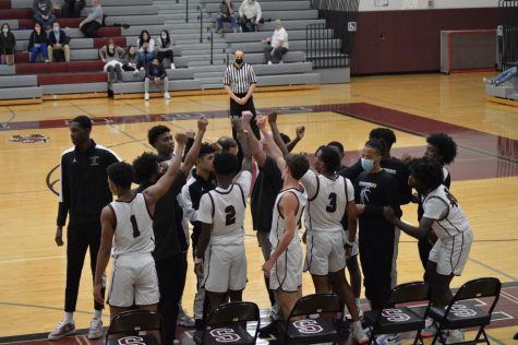 The Stroudsburg boys basketball team come together during a timeout at home.