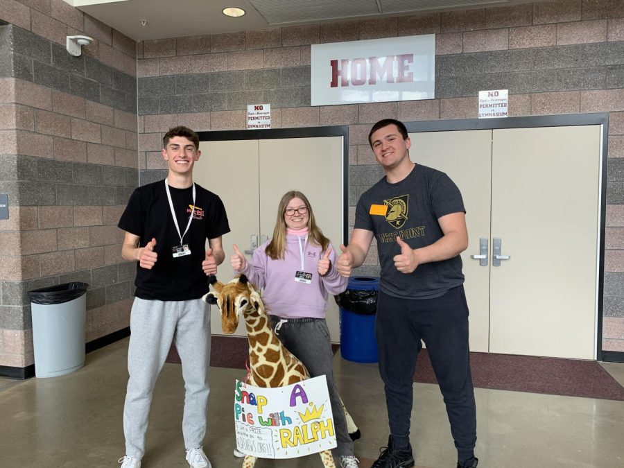 Students take a photo with Ralph the Giraffe!