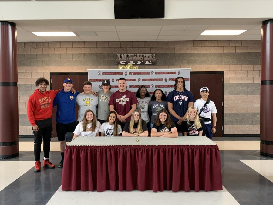 All fourteen athletes stand together after signing their letters of intent.