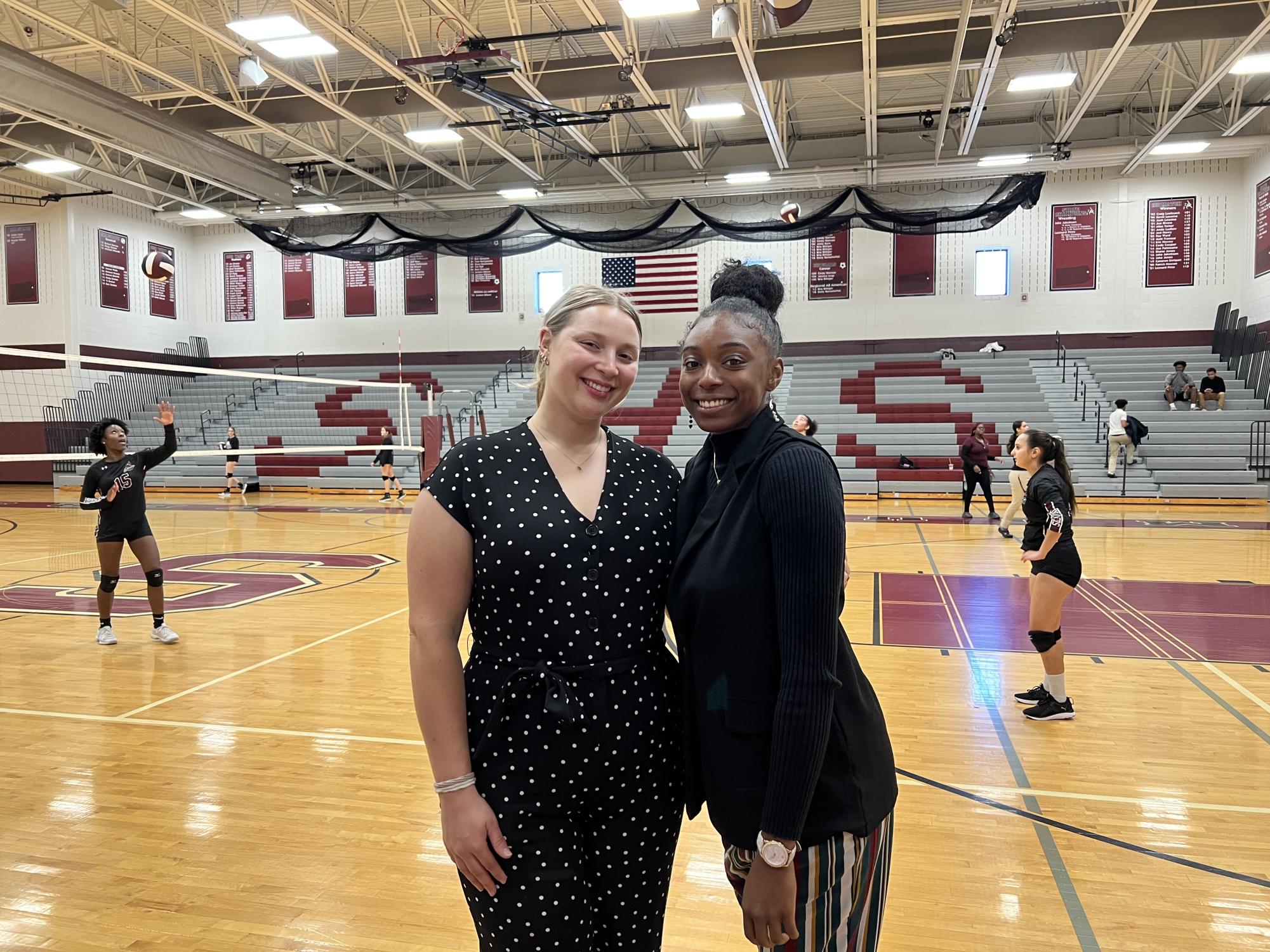 Brittany Hewitt on right, Sarah Buzzard on left, before a volleyball game.