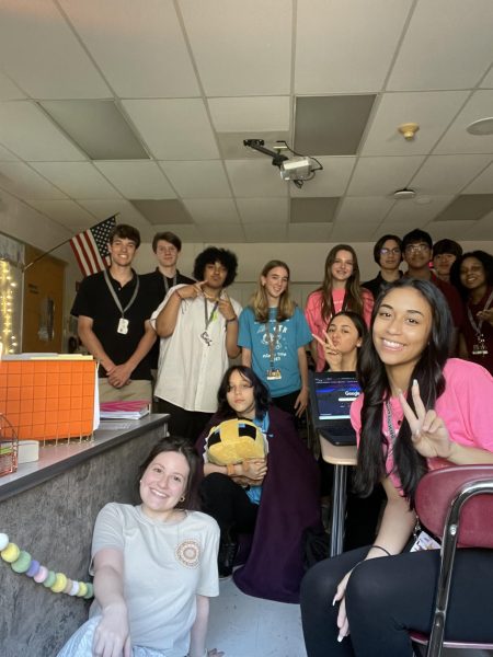 Posed photo of Stroudsburg Junior High teacher Ms. Trebour with her students.