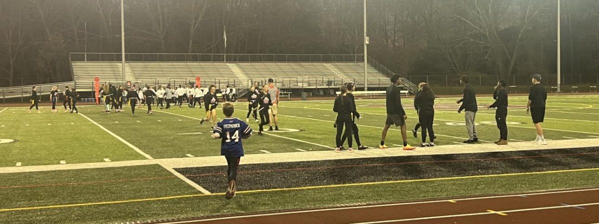 The senior "puff" squad dressed in black for game day. Class President, Eric Card, delegates from the sidelines with his team of coaches: Jelonie Rieara, Kevin Polonia, and Micaiah Brown.  