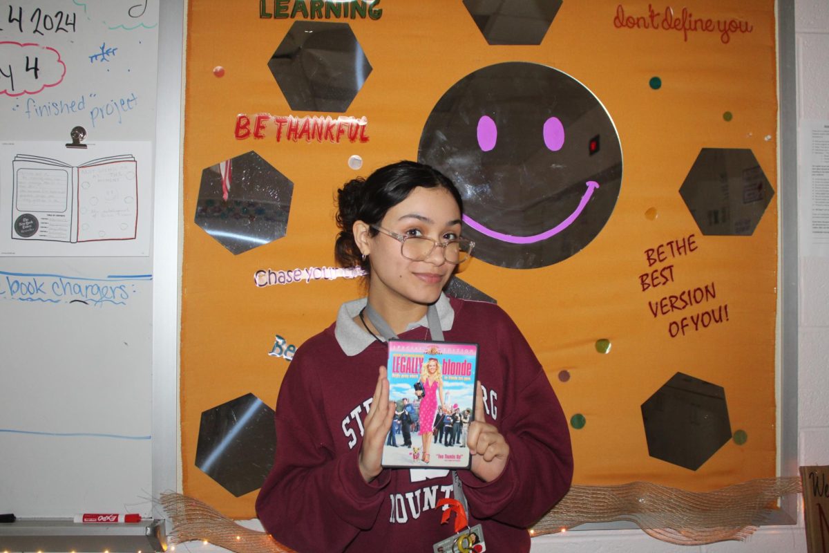 Posed photo of Isabella Rivera, 9, holding a DVD of Legally Blonde.