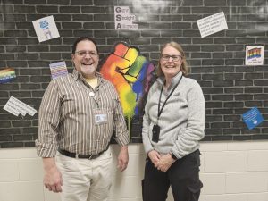 The current GSA advisors, Mr. Steven Rivera and Ms. Gina Cunningham, proudly pose in front of the GSA bulletin board.