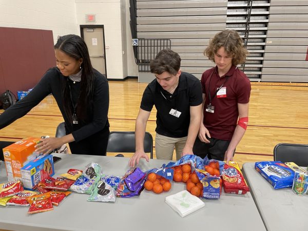 NHS volunteers prepare the snack table for donors after they give blood. 