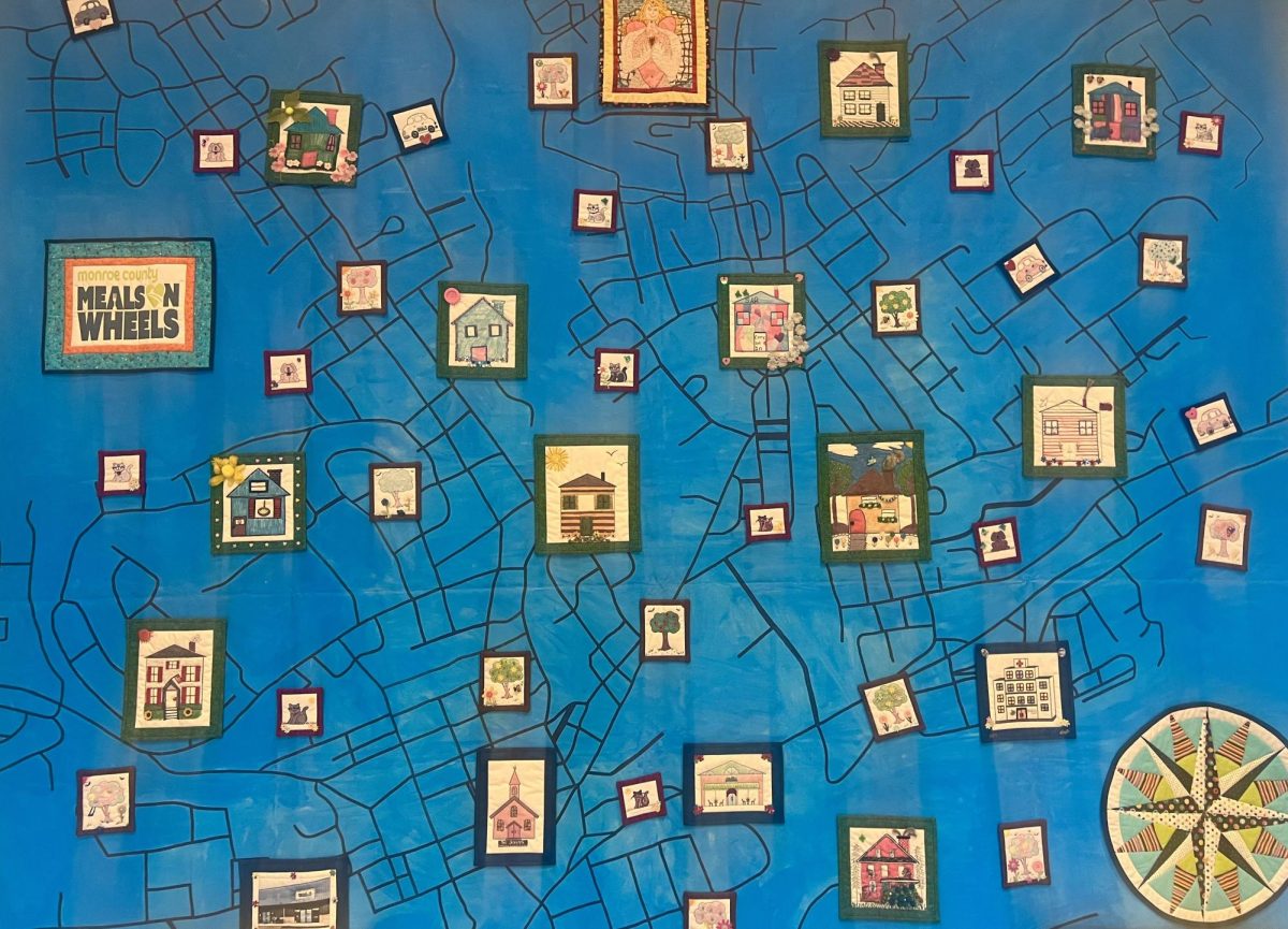 A quilt map created by clients, staff, volunteers symbolizes the unified community. The quilt is a wall display at the Monroe County location. 