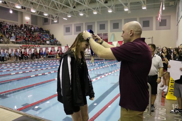 Anna Kirby, 11, getting her medal placed around her neck.