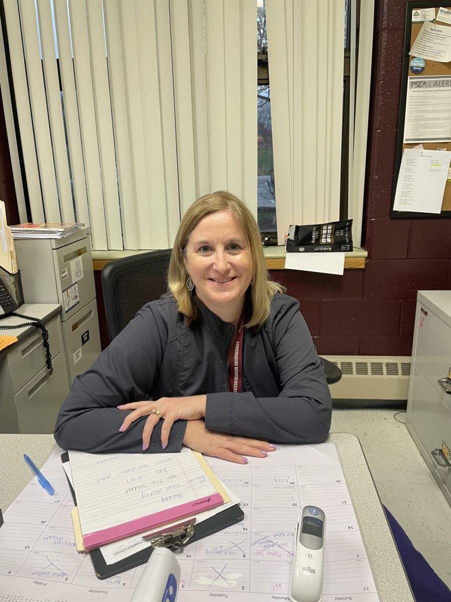 Ms.Cosgrove the school nurse within the Jr.high posing at her desk 