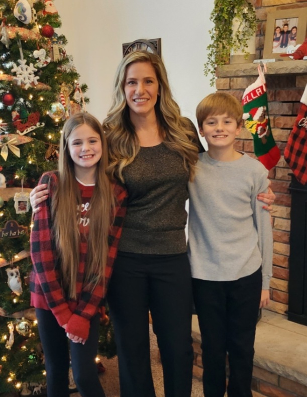 Photo of Ms. Sarti with her 2 children smiling into the camera.