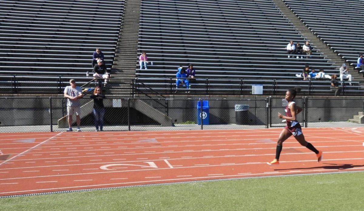 Julia Grant, '26, running on the track in a meet against Pleasant Valley.