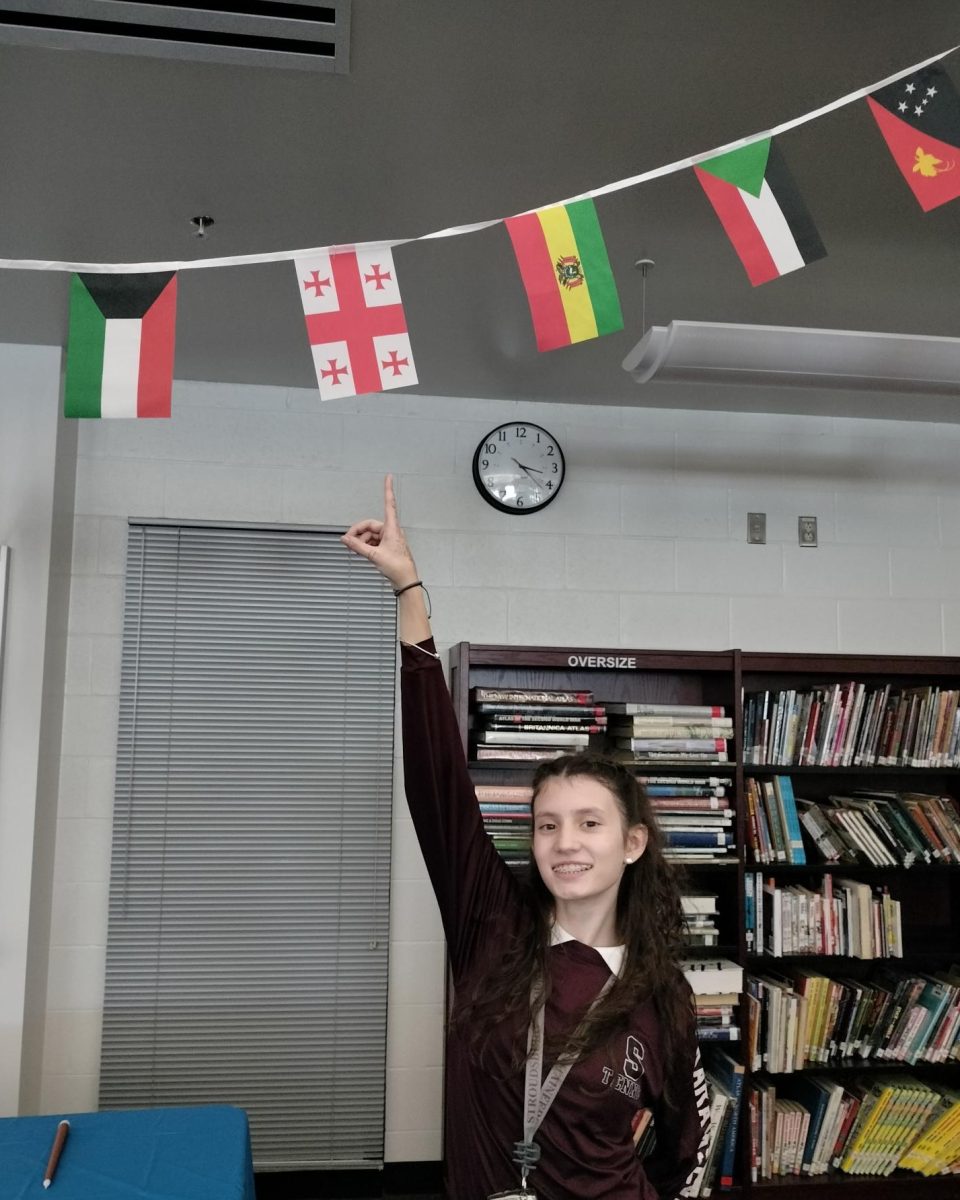 Ana Karataseva, 9, (Macedonian) pointing to the Georgian flag.