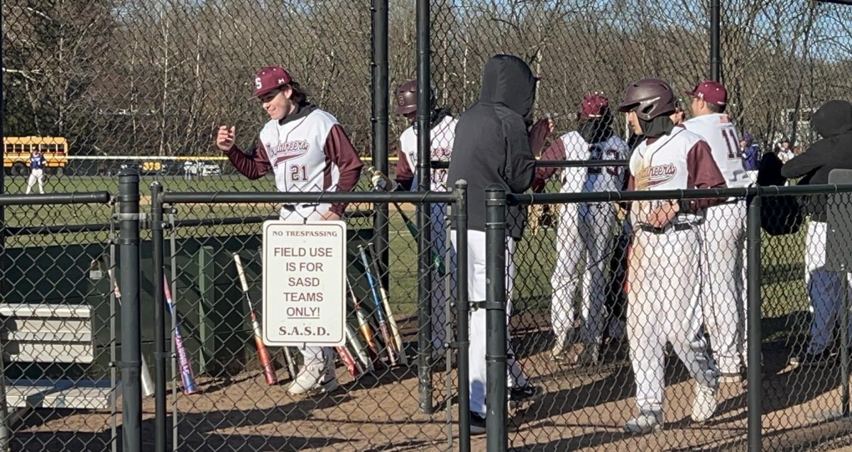 Stroudsburg baseball in the dugout, players prepare to take the field. 