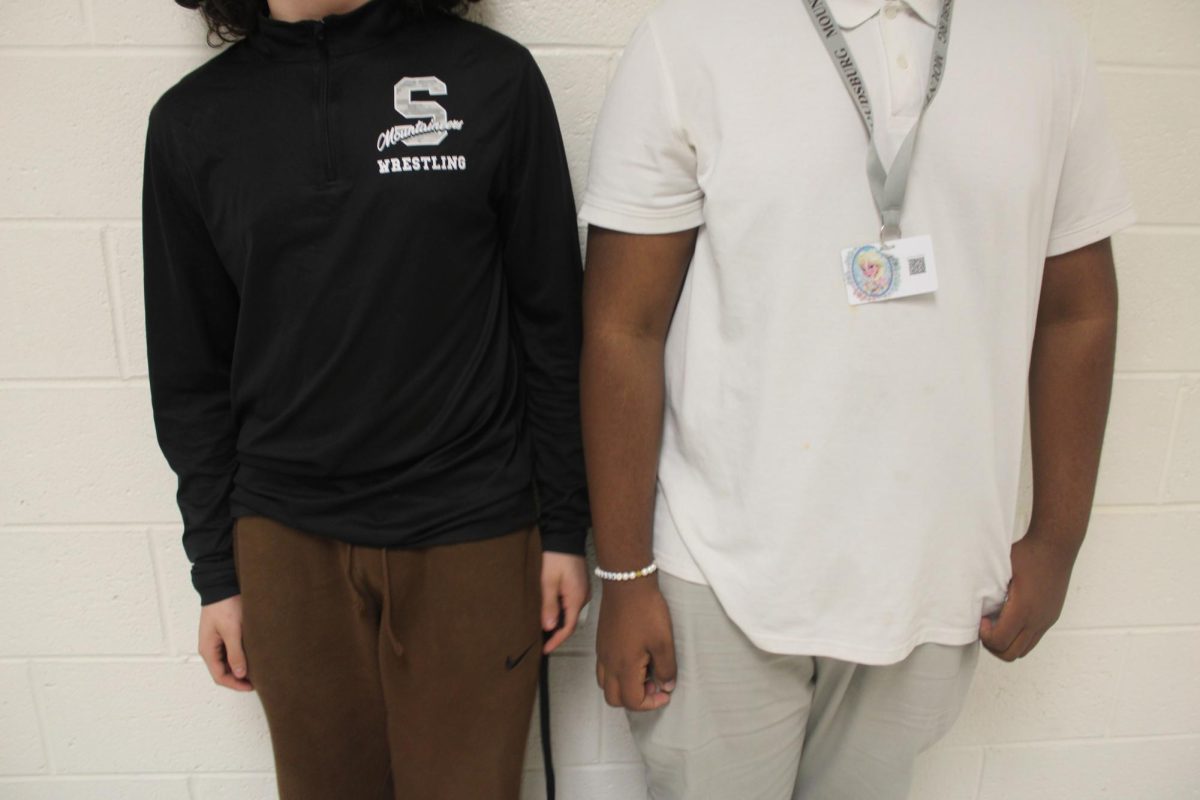 In the halls we see one student (right) who is dress code, and (left) who is not. 