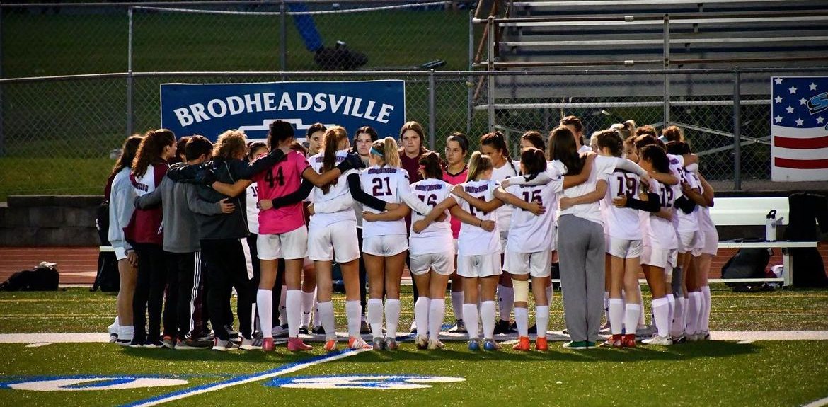 Stroudsburg Girls' Soccer team celebrate in group huddle after game against Pleasant Valley. Photo courtesy of Stroudsburg Girls' Soccer Instagram. 