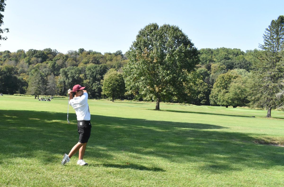 Samuel Diola, '25, driving the ball towards the end of the course