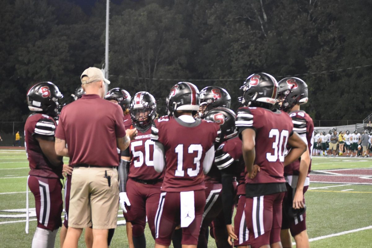 Stroudsburg High School football team huddles up with the coach to make plays