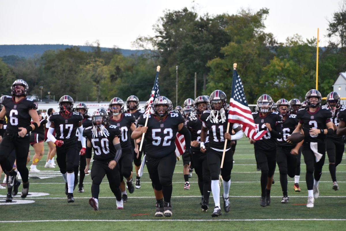 Stroudsburg charging out of the tunnel onto the field, led by C Emaunel Laboy, '25, who is carrying an American flag. Game on September 20, 2024.