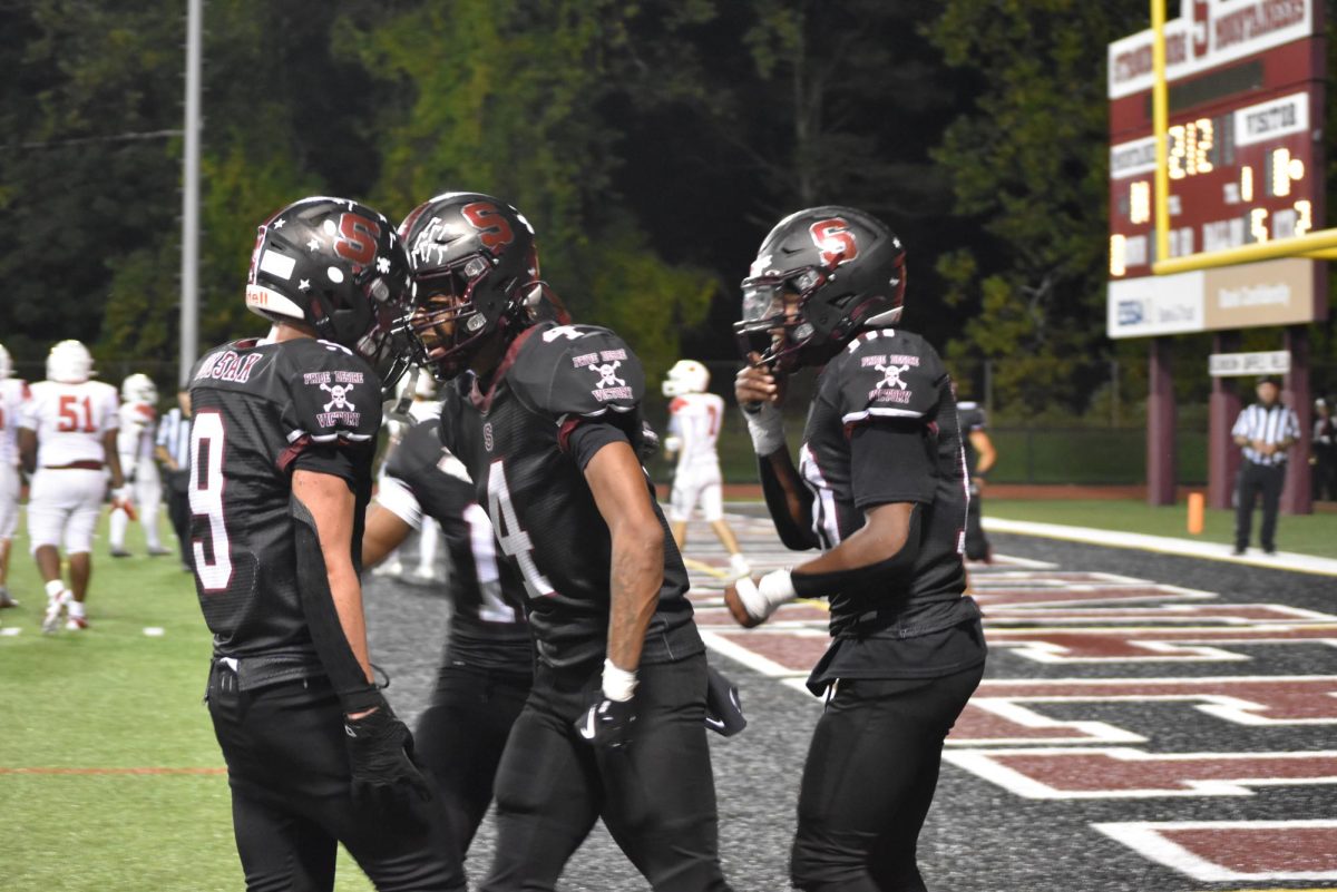 Ethan Dudsak, '25, Jaylin Rieara, '26, and Kamari Coleman, '25, celebrate a touchdown during game against Pocono Mountain East on September 20, 2024.