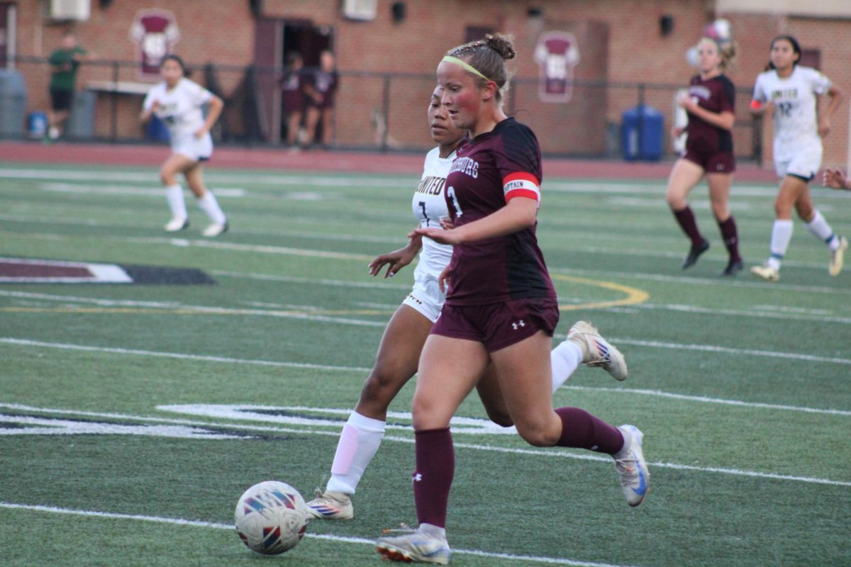 Amelia Neiman, '25, tries to outrun her opponent to score a goal against East Stroudsburg South. 