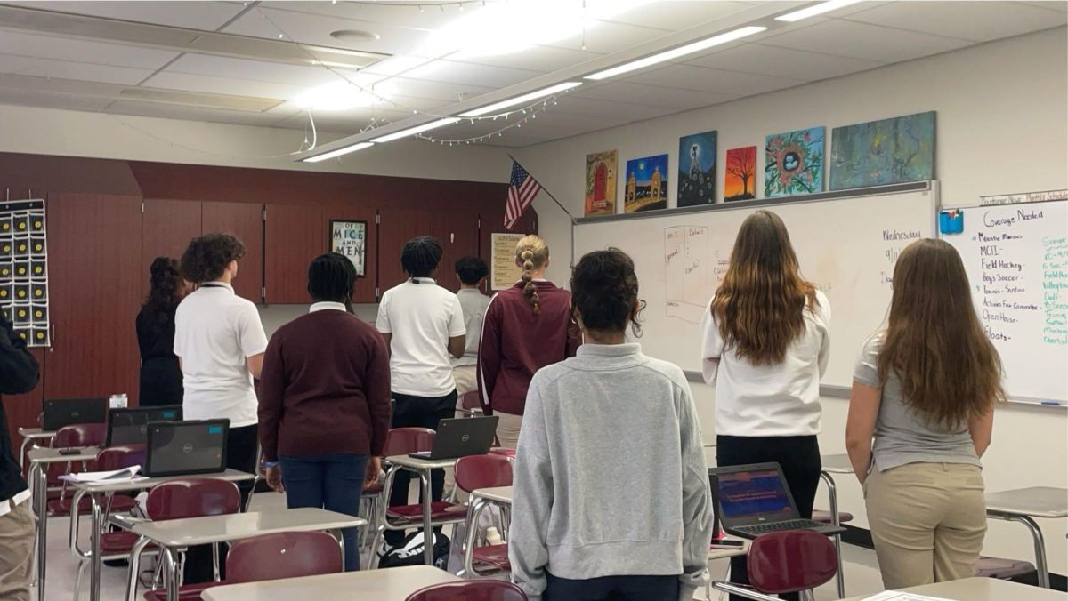 Students recreate the moment of silence the school held on Sept. 11, 2024. 