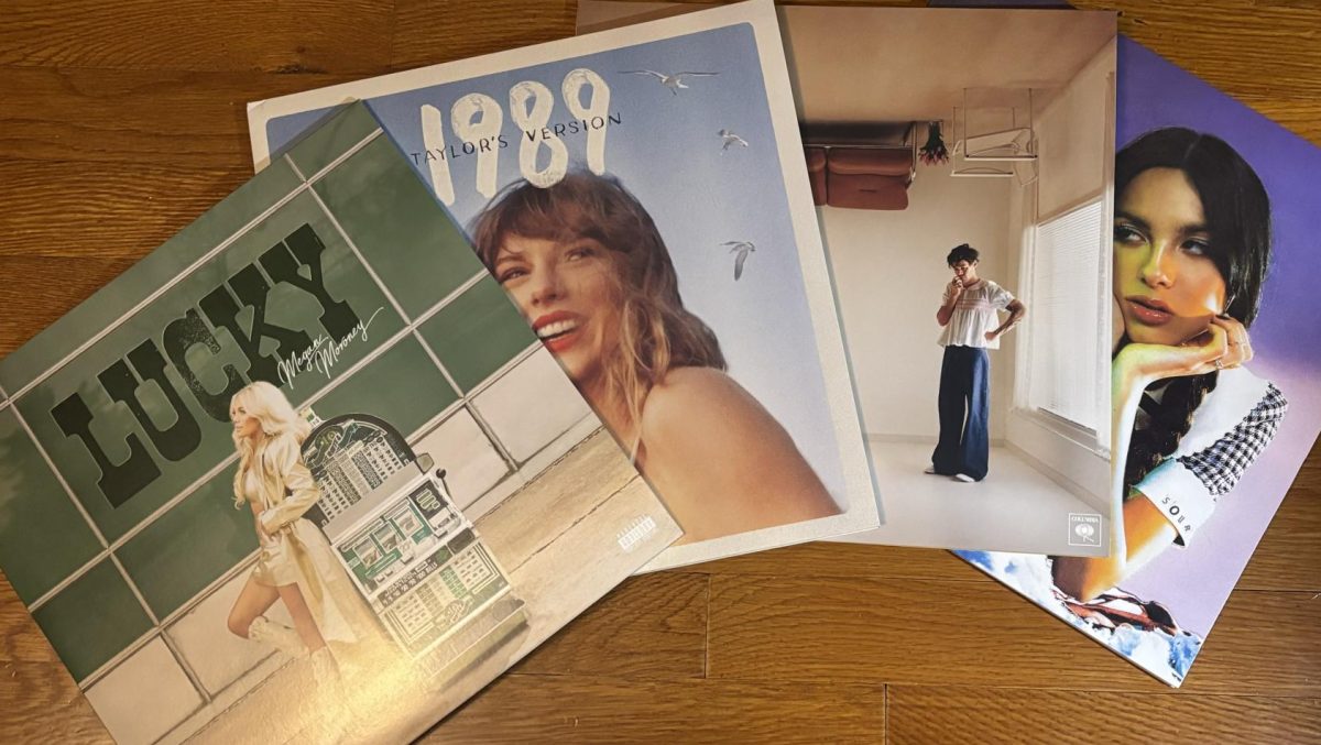 Vinyl album covers of Megan Moroney, Taylor Swift, Harry Styles,  and Olivia Rodrigo. 