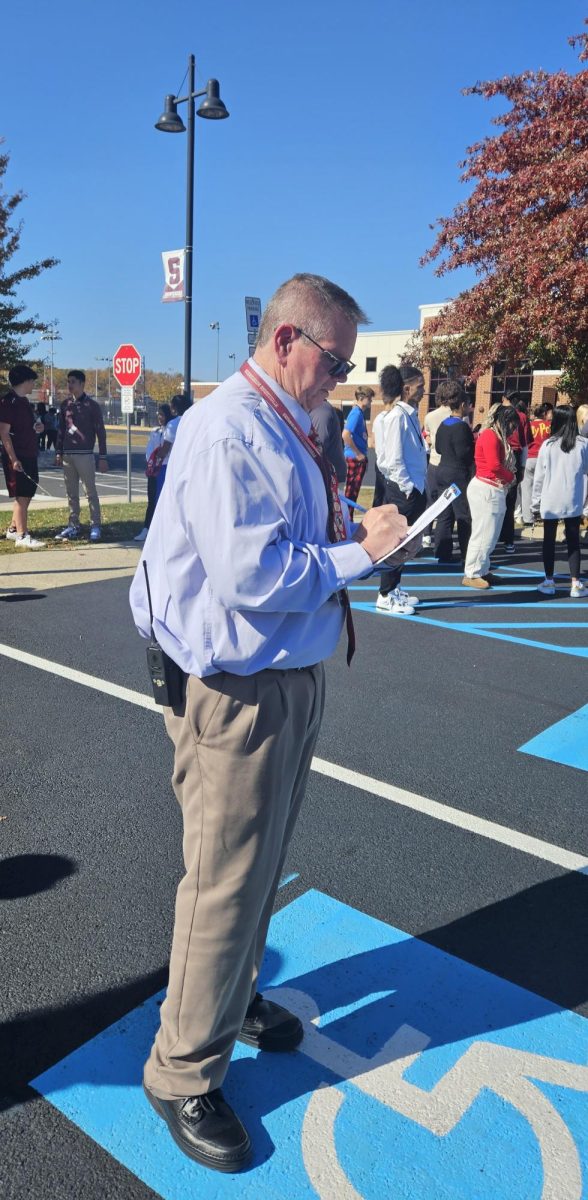 Assistant Principal Burke checks his clipboard for every teacher's attendance during the drill to ensure all have exited the building. October 2024. 