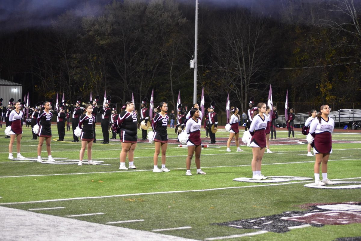 SHS Cheerleaders pledge to the flag before the Football game. 