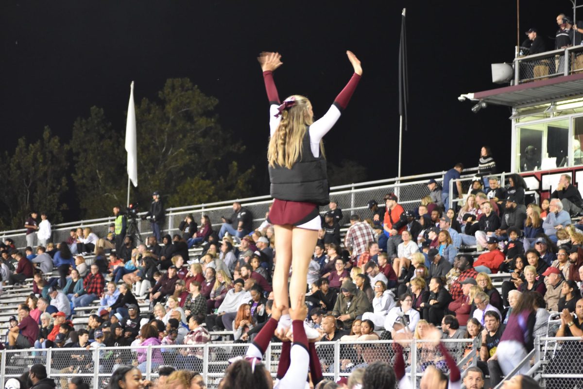 Morgan Tucker, '25, motivates the student section to cheer on Stroudsburg's football team.