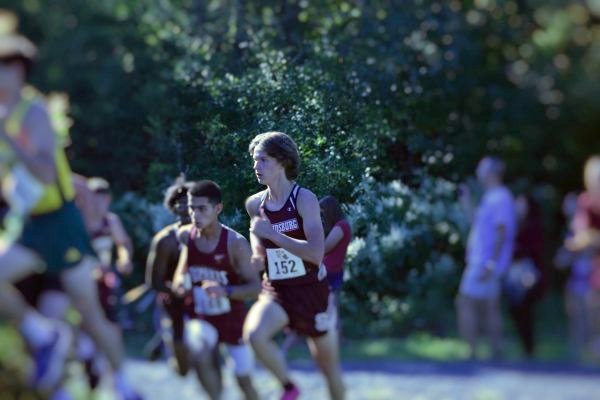 Maxsim Lamberton, '25, running up a hill in a race against five other schools.