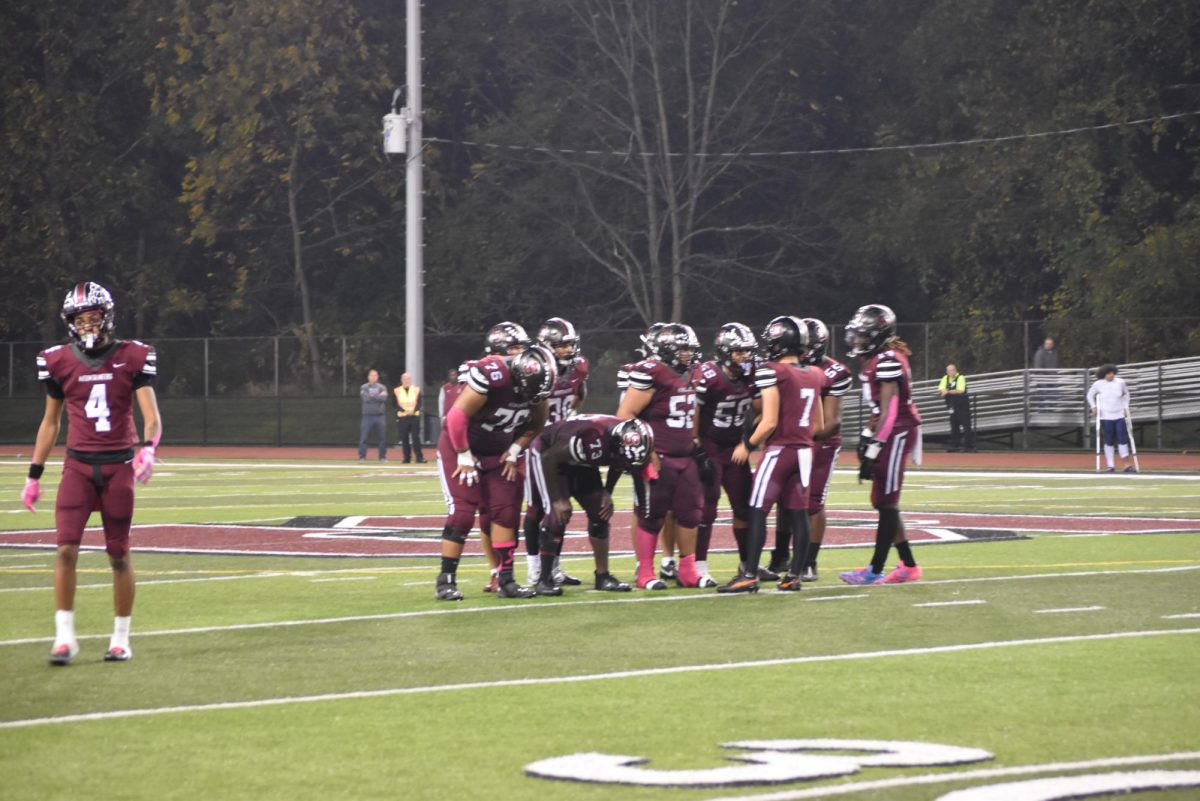 Stroudsburg's offense huddles together before another intense play, October 4, 2024