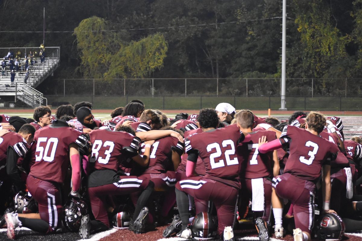 Stroudsburg Football kneels in a team prayer prior to the game vs Pocono Mountain West on October 4, 2024.