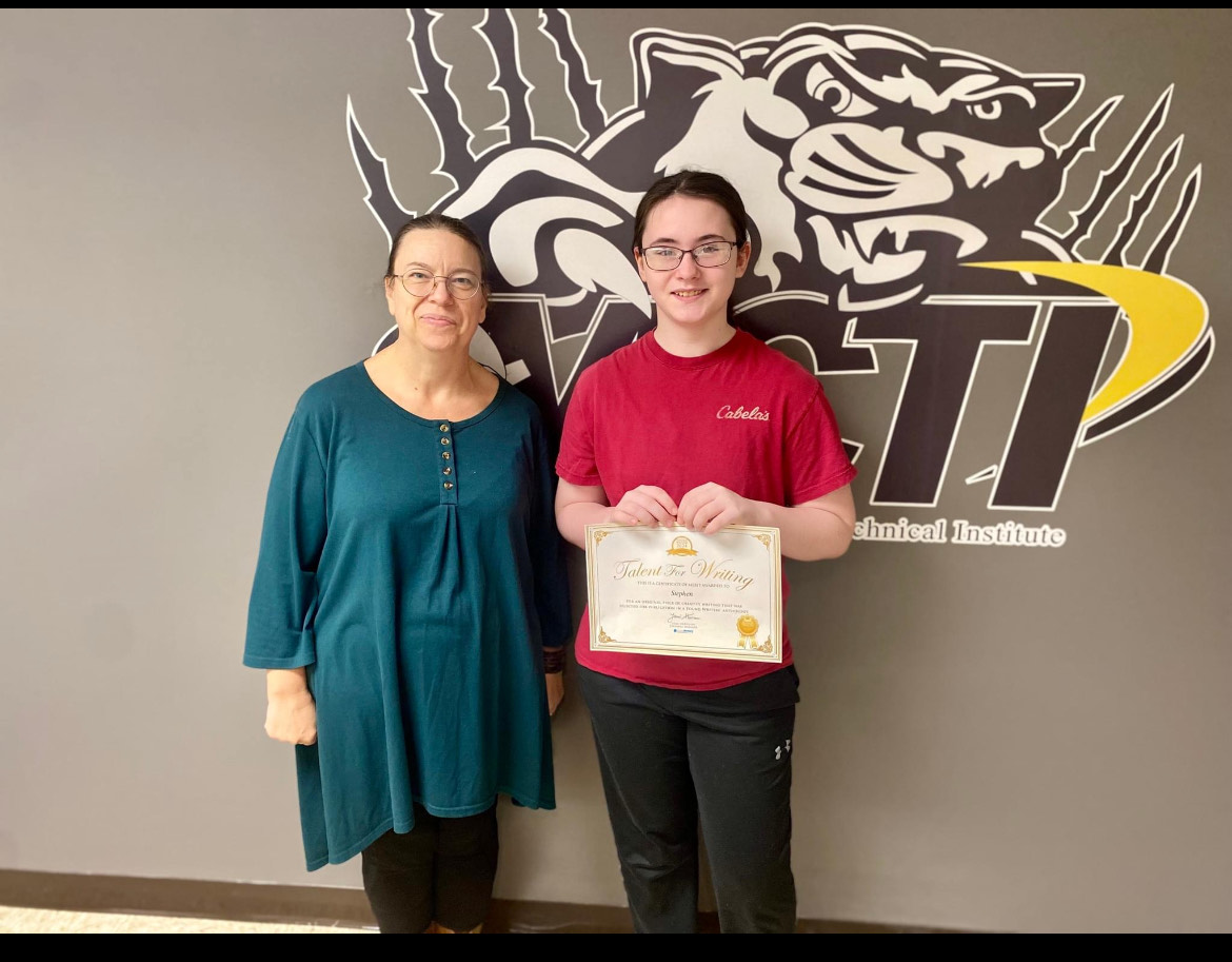 Stephani Chandler, 27’,  posing with her advisor after getting an award for her poem “The Power of Young Colors." 
Photo provided by the MCTI Facebook account. 