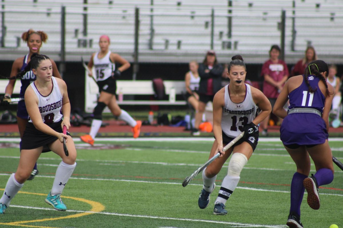 Hailey Dreisbach, '25 and Sydney Moritz, '25 working together to retrieve the ball from South.