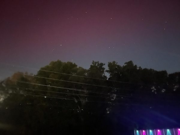 The northern lights from Oct. 10, 2024. The lights show colors of purple and blue across the sky with stars peaking through the background.  Photo provided by student  Madisen Dullen, 25′. 