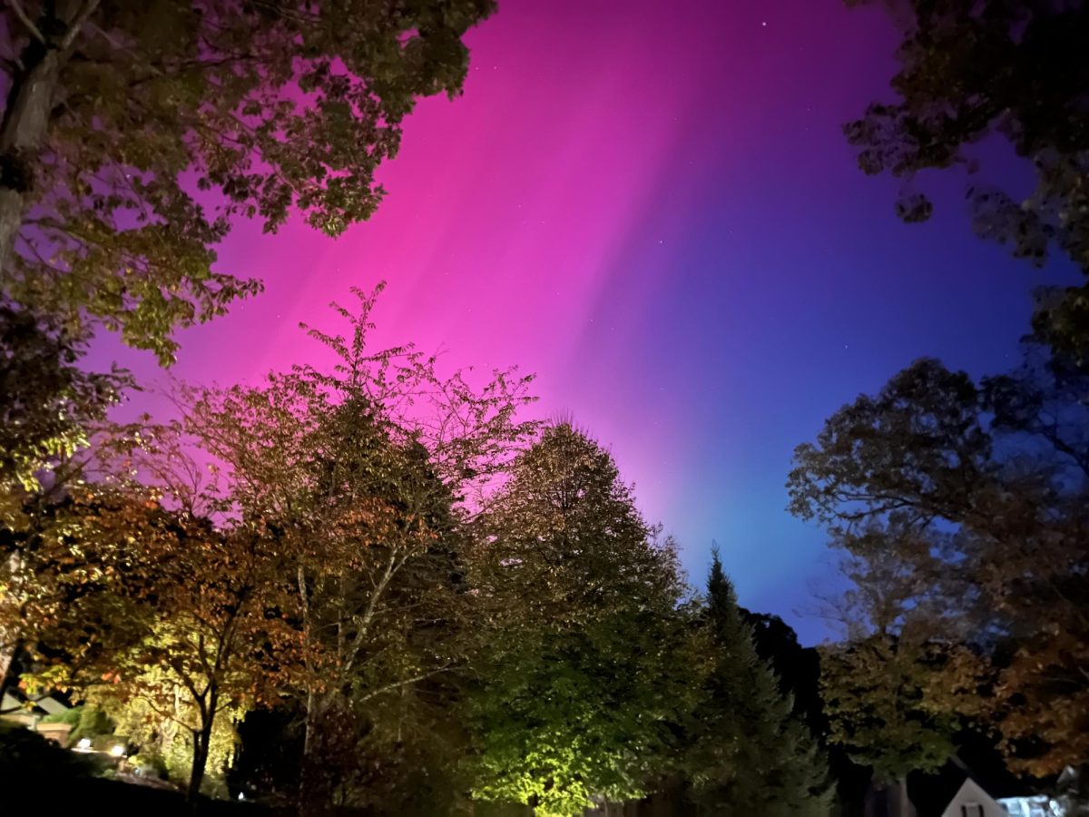 Vibrant purple, pink, and dark blue lights seen in Blue Mountain Lake. 