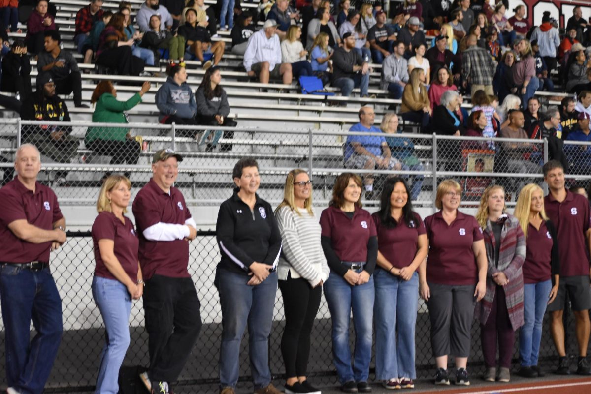 Teachers chosen for "Shirt Off My Back" stand together for a picture after the senior ceremony. 